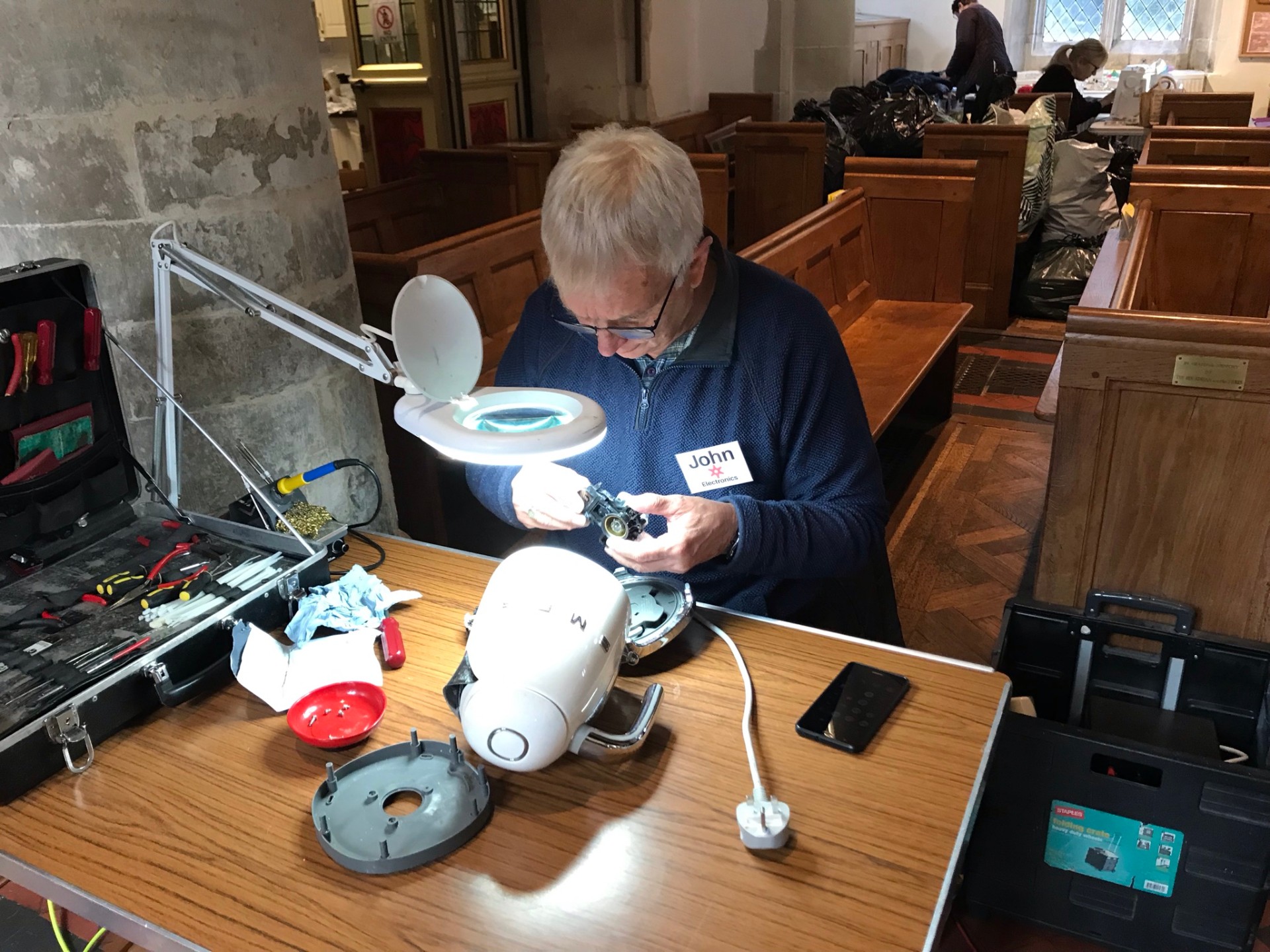 John inspecting the inside of a broken kettle