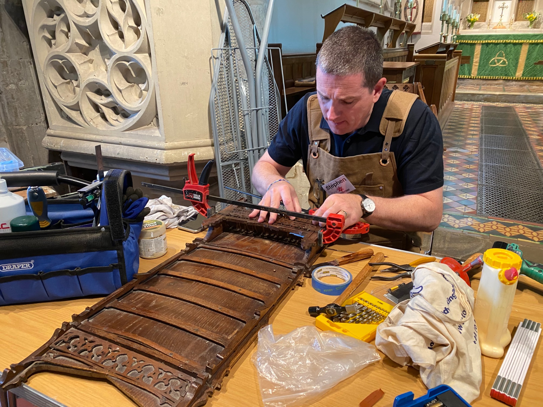 Stephen repairing an antique carved wooden panel